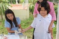 The doctor is taking blood from primary student.